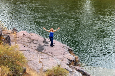 Standing on a rocky ledge by the Blackfoot River near Sheep Flats.